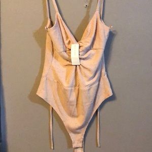 Pinkish tan body suit